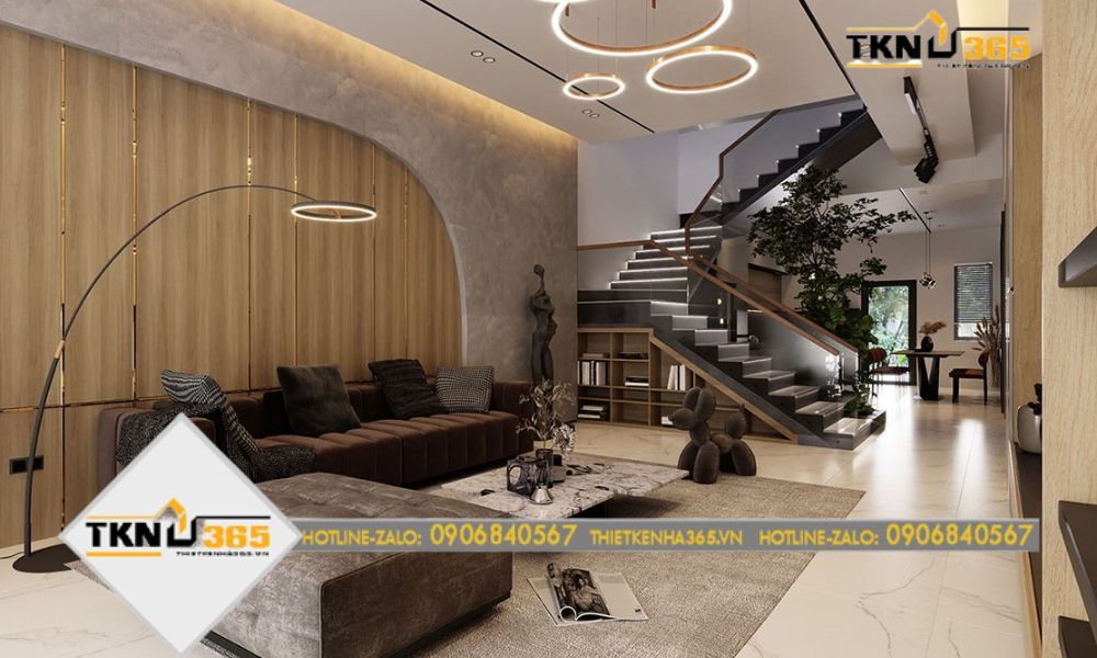 Phòng khách rộng rãi, ấn tượng với sofa nhung sang trọng, bộ đèn trần và đèn sàn lạ mắt