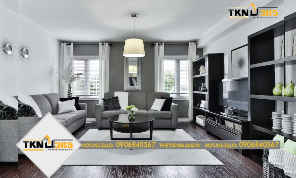 Một góc phòng khách với tông màu xám và đen chủ đạo, sofa vải cùng chiếc bàn thấp nhỏ xinh, thích hợp cho những buổi gặp gỡ bạn bè, người thân