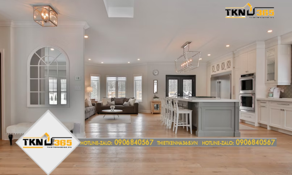 Phòng khách với kết cấu mở liền kề với bếp và phòng ăn trong tông màu pastel và đồ nội thất vintage, tạo cảm giác yên bình và lãng mạn