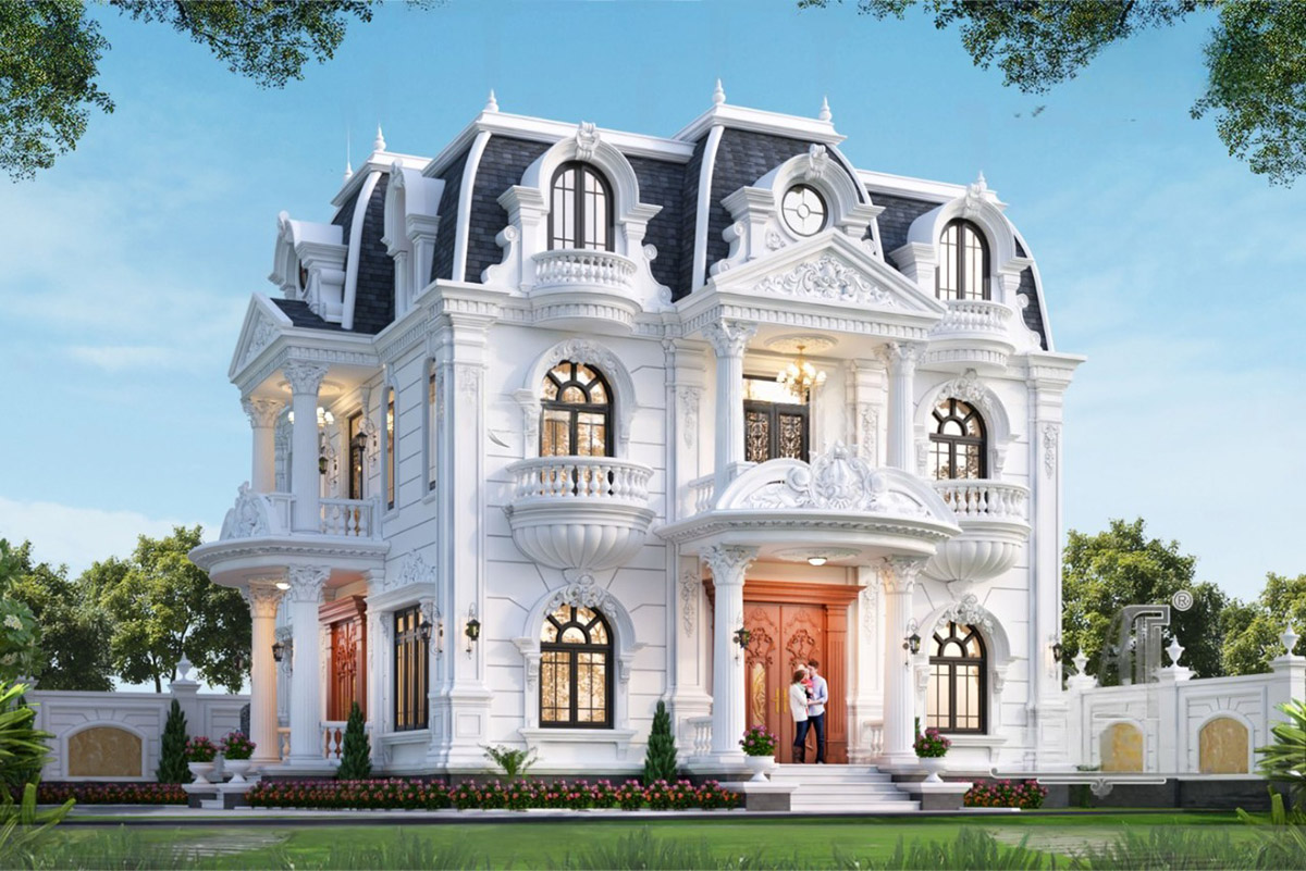 Biệt thự tọa lạc trên khu đất 2 mặt tiền thoáng rộng, nổi bật với hình khối bề thế, mái Mansard xanh than đặc trưng và tông trắng tinh khôi chủ đạo.