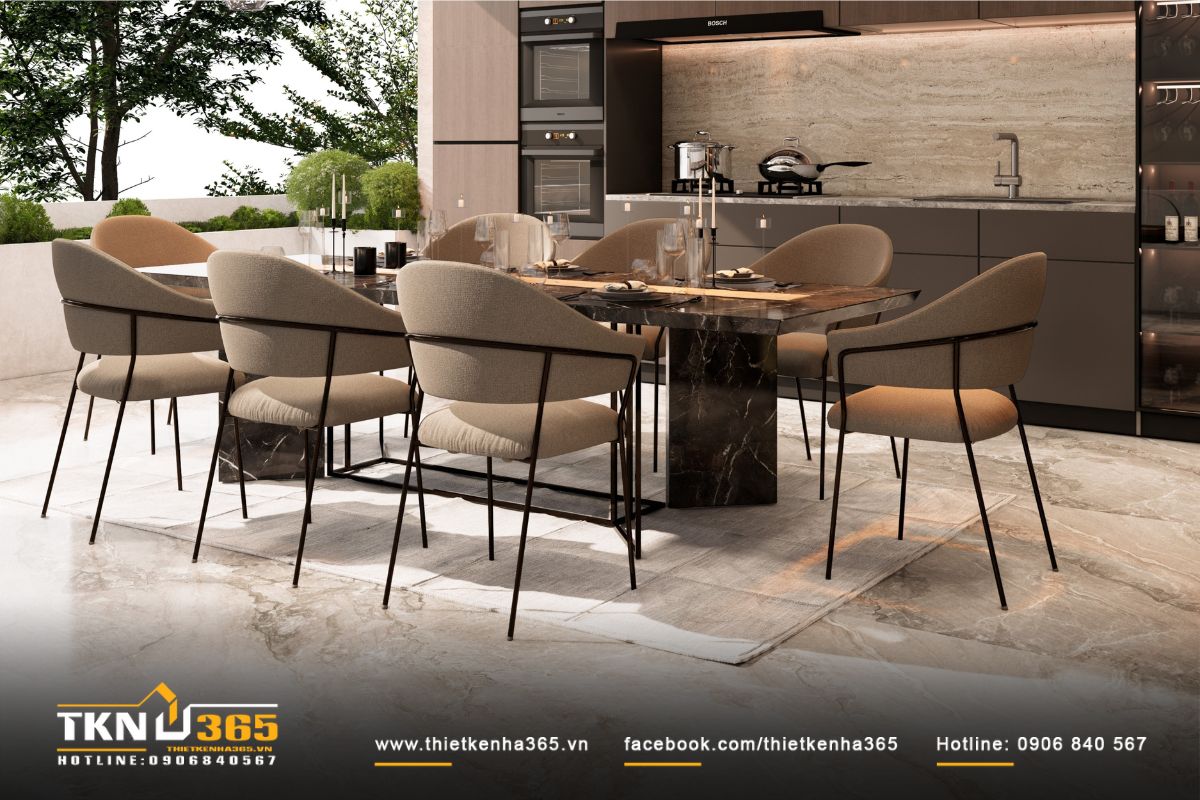 Bàn ăn đá marble tông nâu phối cùng ghế vải dáng cong, ánh sáng ban ngày phản chiếu lên bề mặt đá giúp không gian trở nên tinh tế và gần gũi
