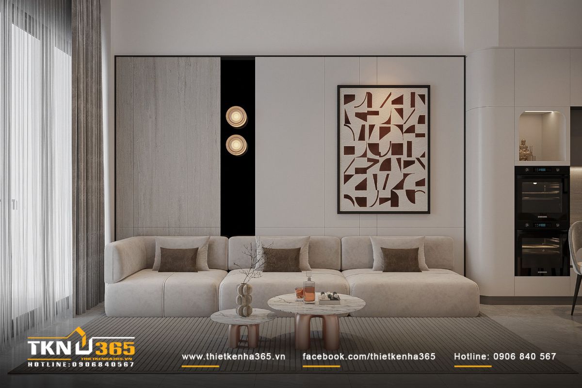 Không gian tiếp khách sử dụng sofa khối mềm màu be sáng, đặt sát tường giúp tối ưu diện tích trong nhà phố hẹp ngang