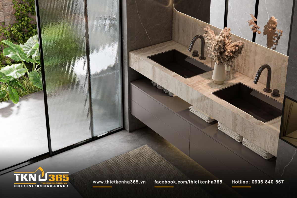 Khu vực lavabo đôi bằng đá tự nhiên nguyên khối, kết hợp vòi đen nhám và đèn hắt khe dưới bệ tạo hiệu ứng nổi bật, tinh tế và hiện đại