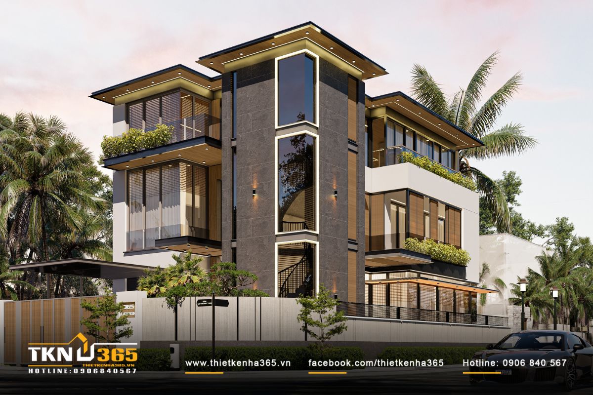 Biệt thự 3 tầng hai mặt tiền nổi bật giữa khu phố hiện đại, sử dụng gam màu trung tính sang trọng cùng khối đá ốp tối màu làm điểm nhấn