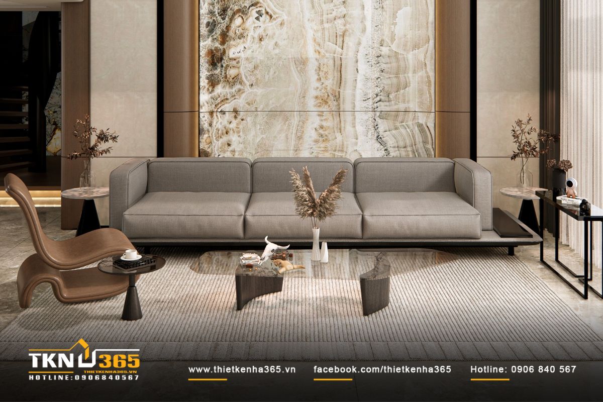 Bức tường ốp đá tự nhiên sau sofa trở thành điểm nhấn thị giác, vân đá như dòng chảy của thời gian trong không gian hiện đại