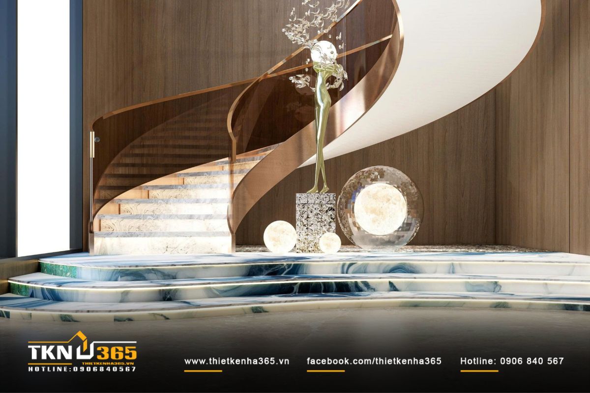 Cầu thang uốn cong mềm mại như một tác phẩm điêu khắc giữa không gian, tôn vinh vẻ đẹp của đường nét và tỷ lệ