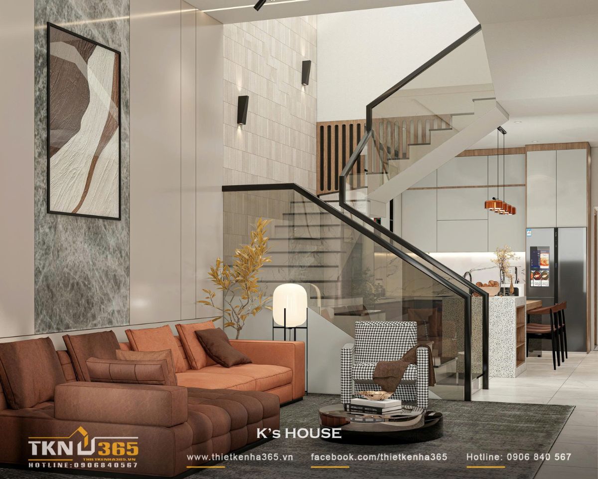 Bộ sofa da nâu đất và ghế caro trung tính tạo điểm nhấn thị giác, cân bằng giữa cảm giác hiện đại và gần gũi