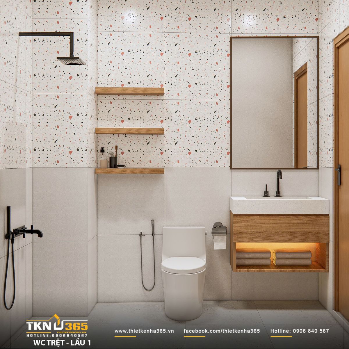 Phòng vệ sinh lát gạch terrazzo sáng, điểm nhấn phụ kiện đen mờ và kệ gỗ treo giữ không gian sạch sẽ, tinh tế