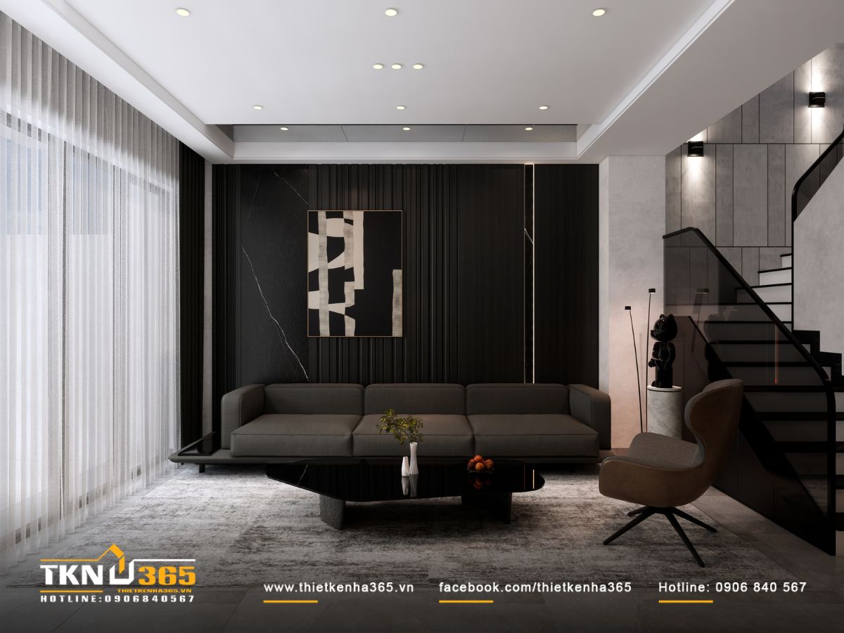 Bức tường sau sofa ốp đá đen vân trắng và lam gỗ dọc, hình thành phông nền đường nét mạnh mẽ cho phòng khách