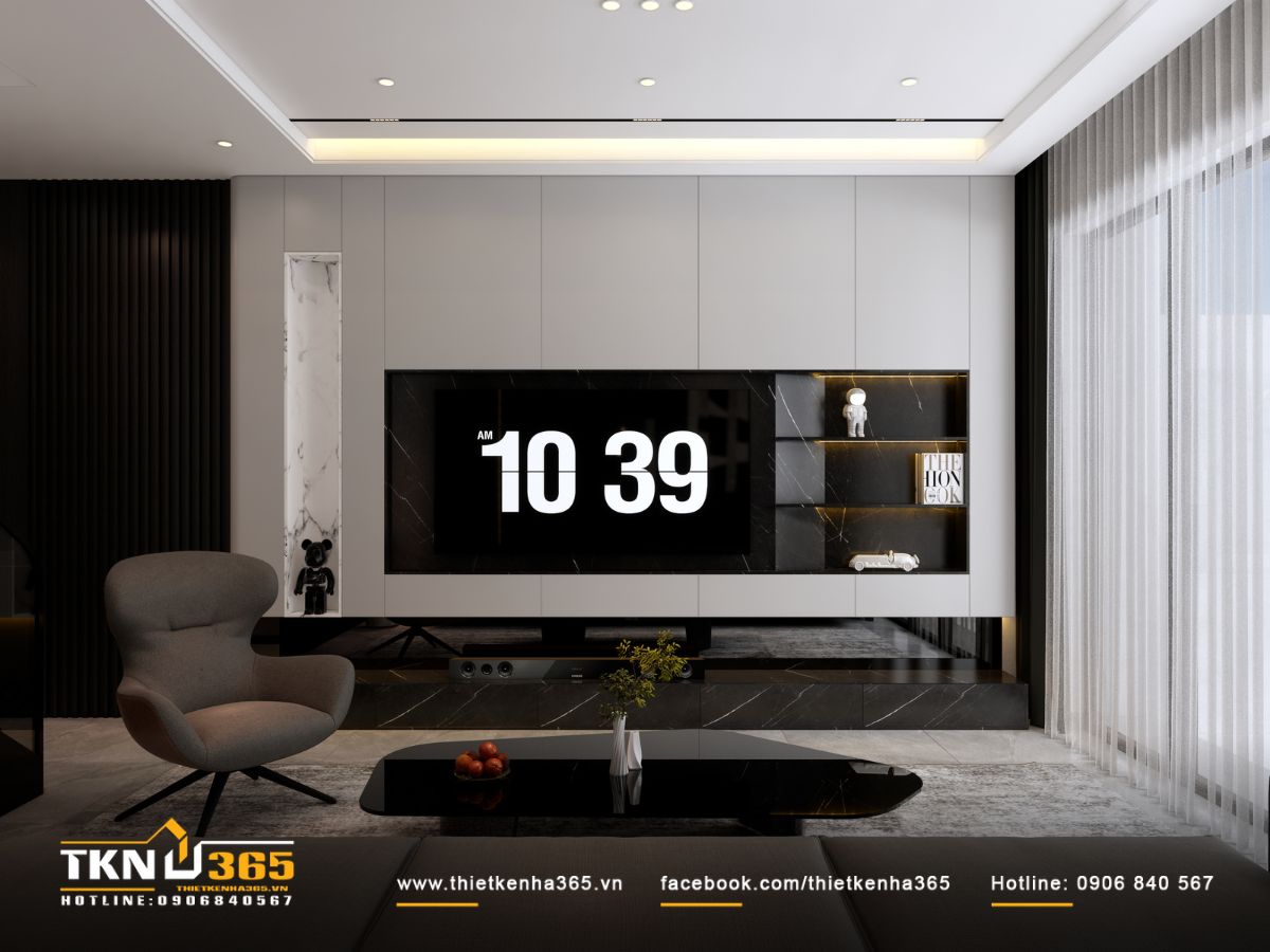 Ánh sáng tự nhiên len lỏi qua lớp rèm voan, lan tỏa dịu nhẹ vào phòng khách, giảm độ tương phản của bảng màu đen và ghi