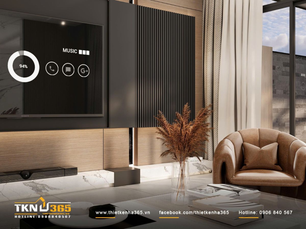 Ghế bành da nâu đặt lệch một góc, tạo điểm tựa thư giãn ấm áp cho những khoảnh khắc đọc sách và nghỉ ngơi