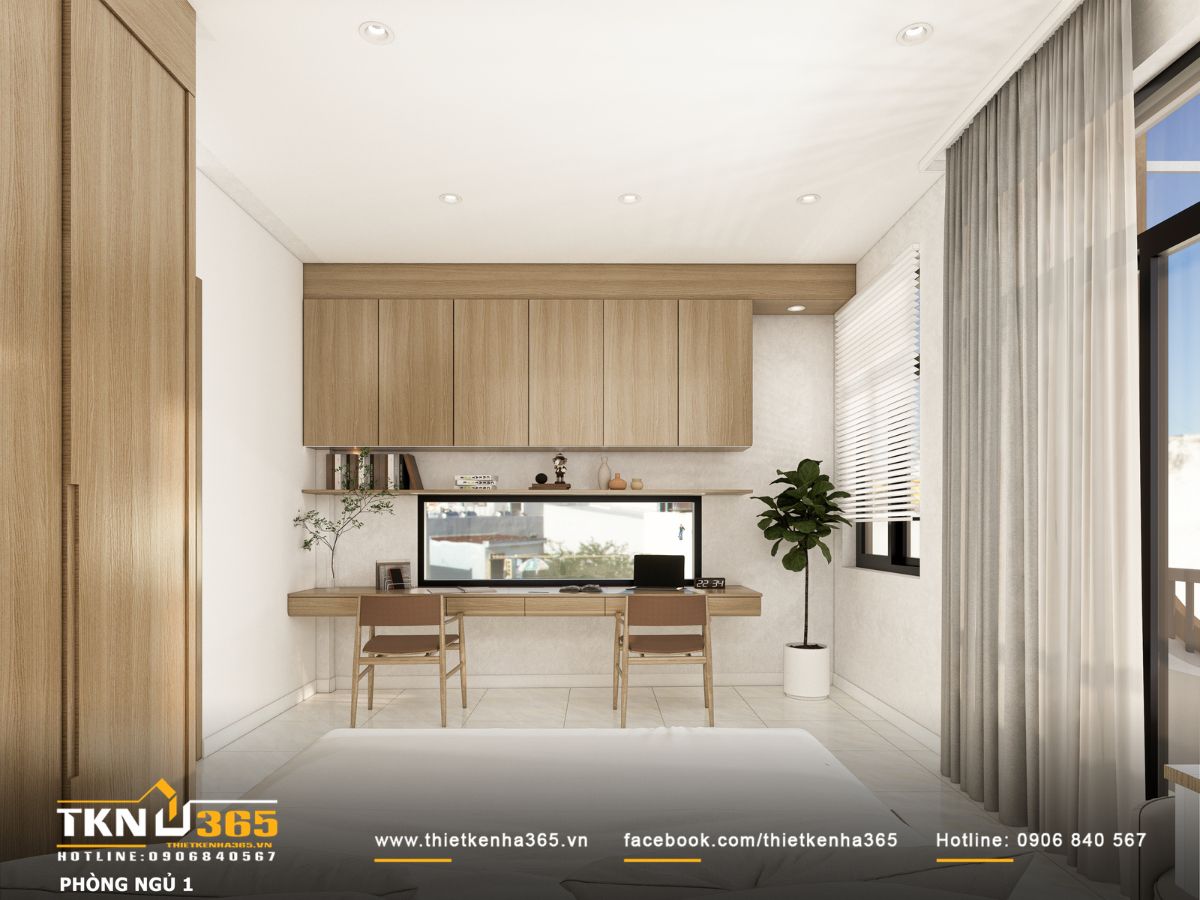 Góc làm việc sáng thoáng với bàn chạy dài theo tường và hệ tủ treo tăng không gian lưu trữ đồ dùng