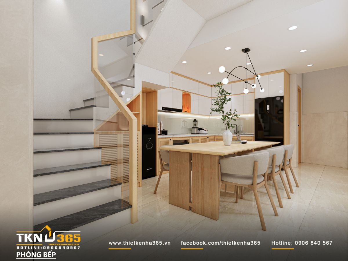 Gầm cầu thang tận dụng làm tủ và kệ trang trí, đi cùng lan can kính và tay vịn gỗ giúp ánh sáng lan tỏa liền mạch giữa các khu vực chức năng