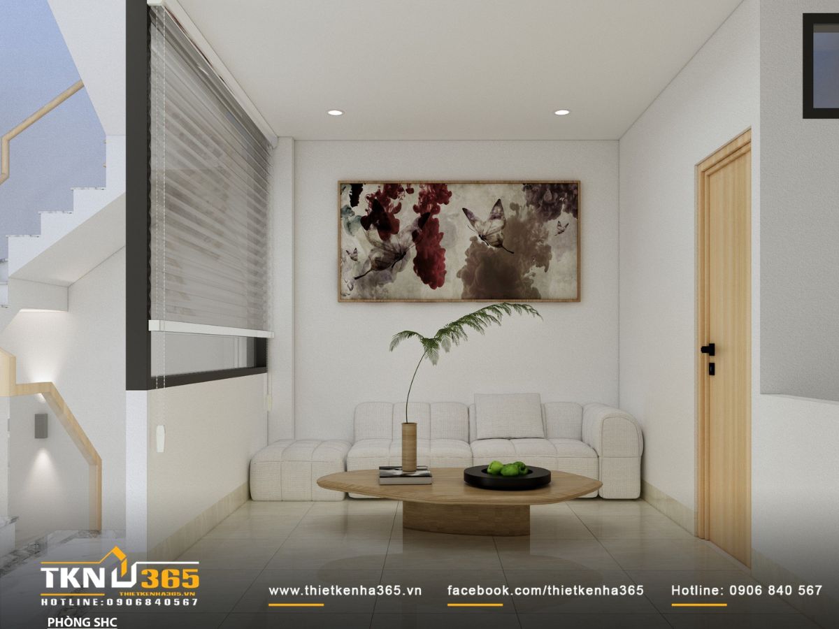 Phòng sinh hoạt chung với sofa dáng thấp và bàn tròn gỗ - một góc thư giãn nhẹ nhàng cho cả gia đình trò chuyện, đọc sách