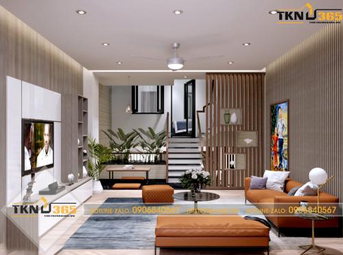 Phối cảnh phòng khách với bộ ghế sofa màu cam cùng những bức tranh nghệ thuật độc đáo